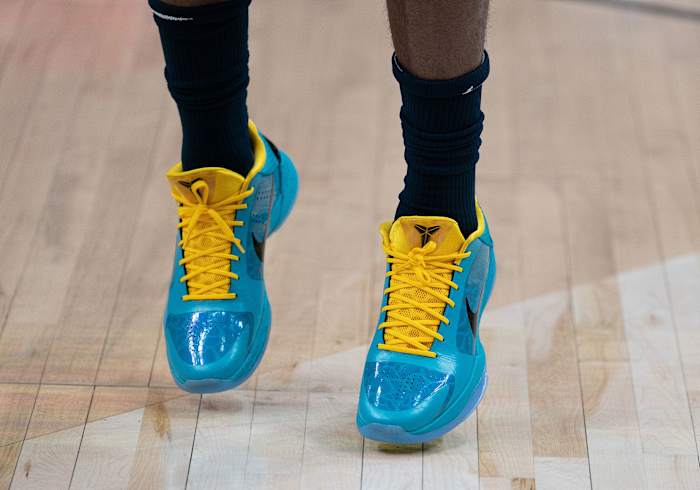 View of blue and yellow Nike Kobe shoes.